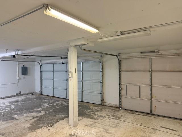 garage with a garage door opener and electric panel