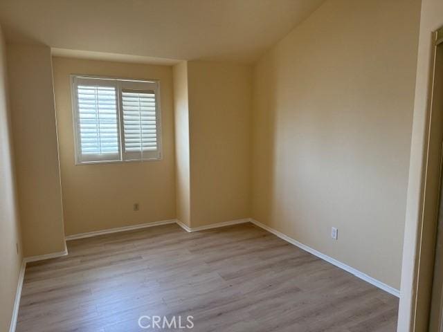 spare room featuring light wood-type flooring