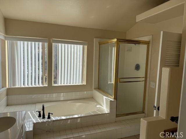 bathroom featuring vanity and shower with separate bathtub