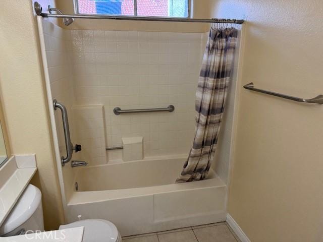 bathroom with tile patterned floors, toilet, and shower / tub combo