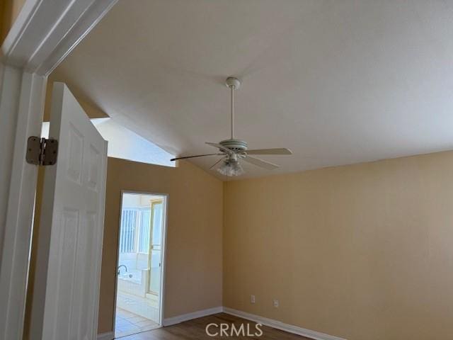 unfurnished room with ceiling fan and lofted ceiling