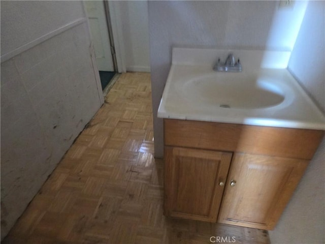 bathroom featuring parquet floors and sink