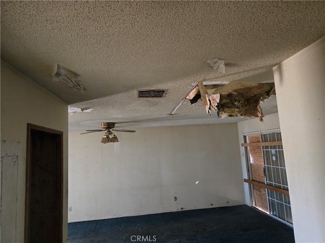 spare room with ceiling fan and a textured ceiling