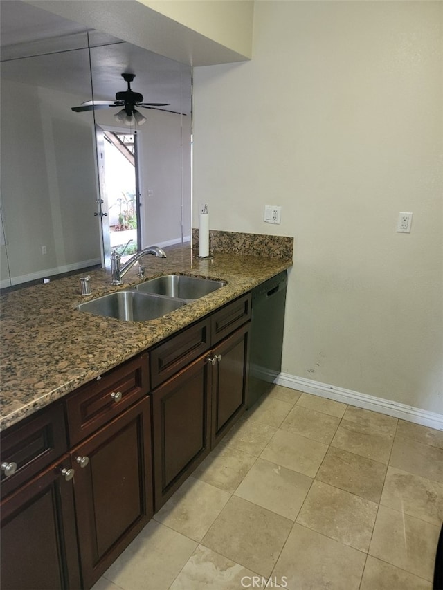 kitchen with sink, light tile patterned floors, ceiling fan, dark stone countertops, and black dishwasher