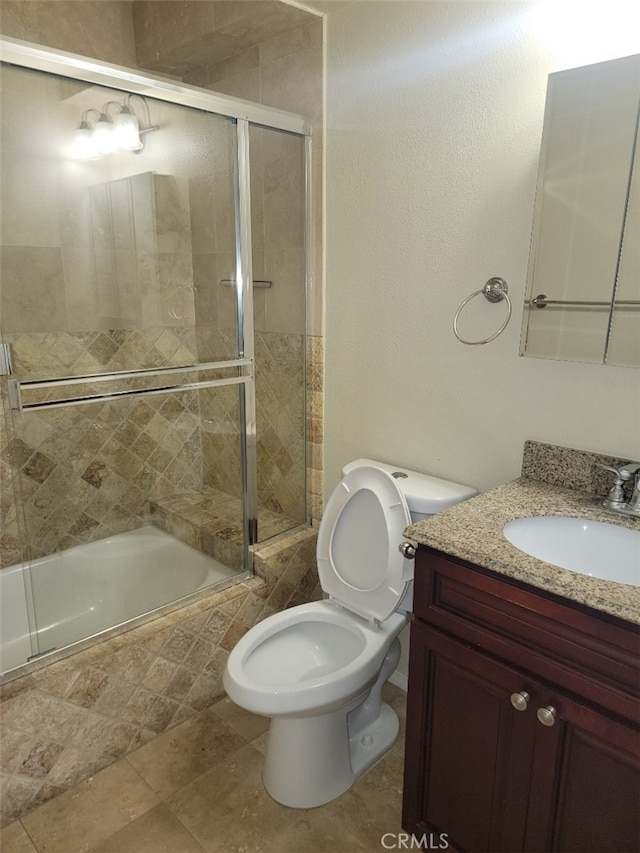 full bathroom featuring toilet, vanity, and shower / bath combination with glass door