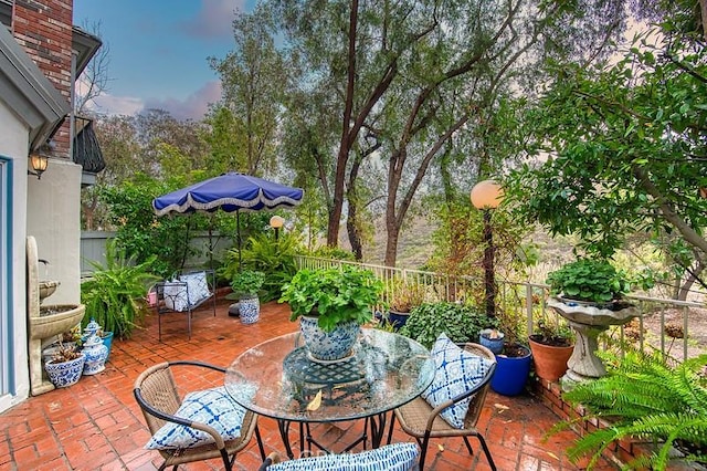 view of patio featuring outdoor dining area and fence