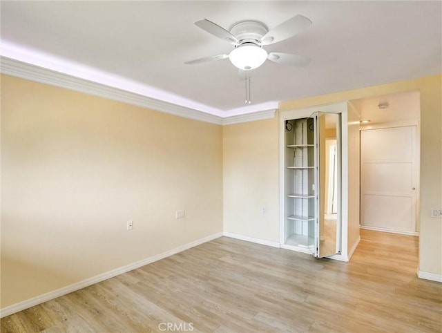 unfurnished room featuring crown molding, light hardwood / wood-style floors, and ceiling fan