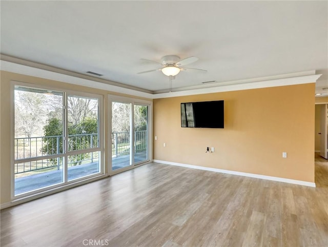 spare room with ornamental molding, ceiling fan, and light hardwood / wood-style flooring