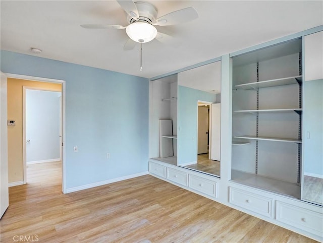 interior space featuring two closets, light hardwood / wood-style floors, and ceiling fan