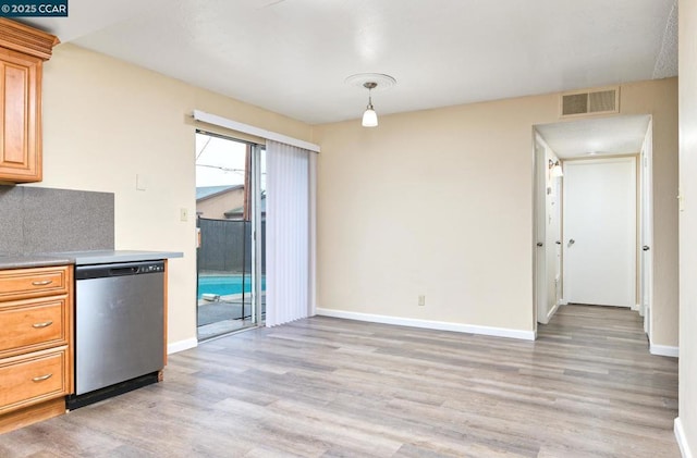 kitchen featuring tasteful backsplash, decorative light fixtures, dishwasher, and light hardwood / wood-style floors