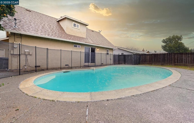 view of pool at dusk