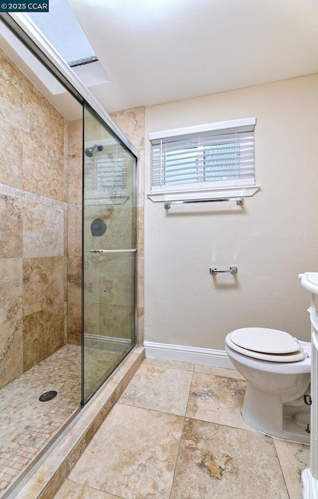 bathroom featuring toilet and an enclosed shower