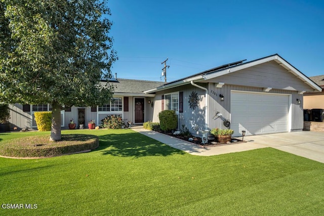 ranch-style house featuring a garage and a front lawn