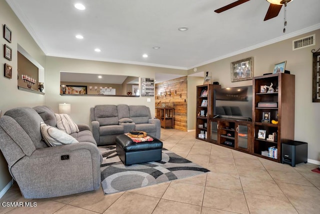 living room featuring light tile patterned floors, ornamental molding, and ceiling fan