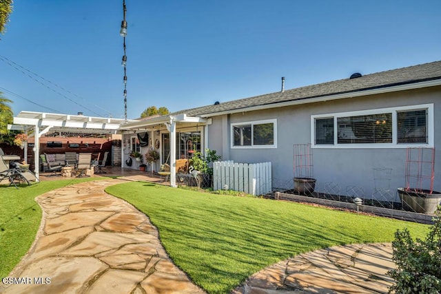 rear view of property featuring a lawn, a patio area, and a pergola