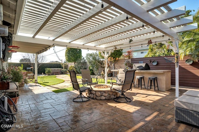 view of patio / terrace with a pergola, an outdoor fire pit, and exterior bar