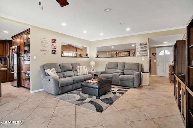 living room with light tile patterned floors, crown molding, and ceiling fan