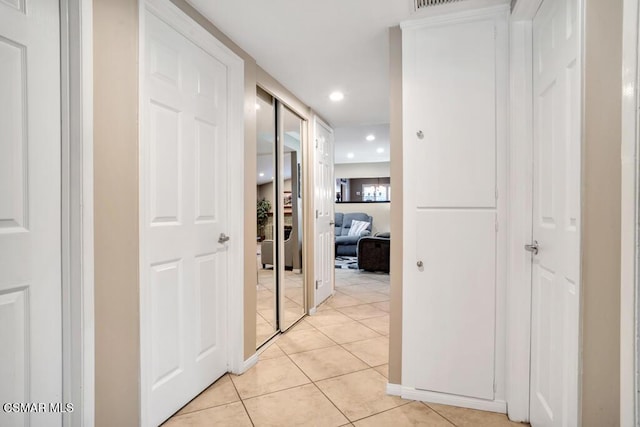 corridor featuring light tile patterned floors