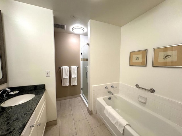 bathroom featuring vanity, independent shower and bath, and tile patterned flooring