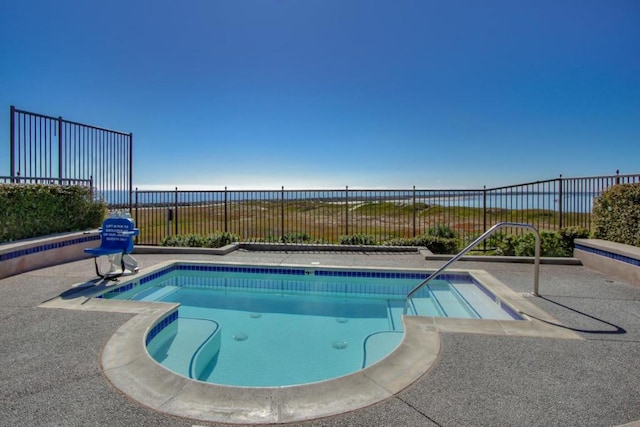 view of swimming pool featuring a water view