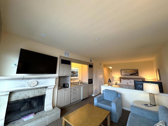 living room featuring sink and light carpet