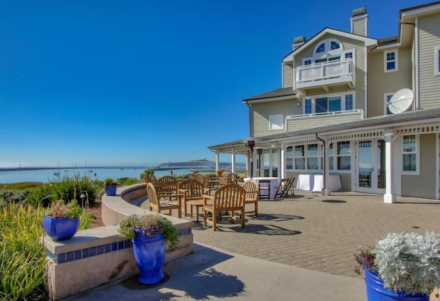 view of patio featuring french doors and a water view