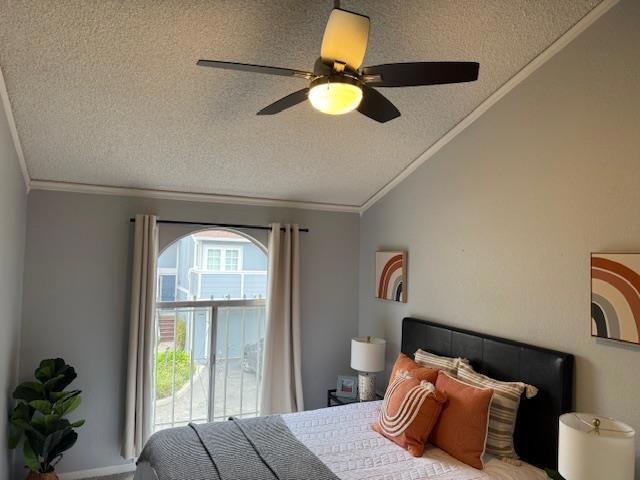 bedroom featuring ornamental molding, vaulted ceiling, and a textured ceiling