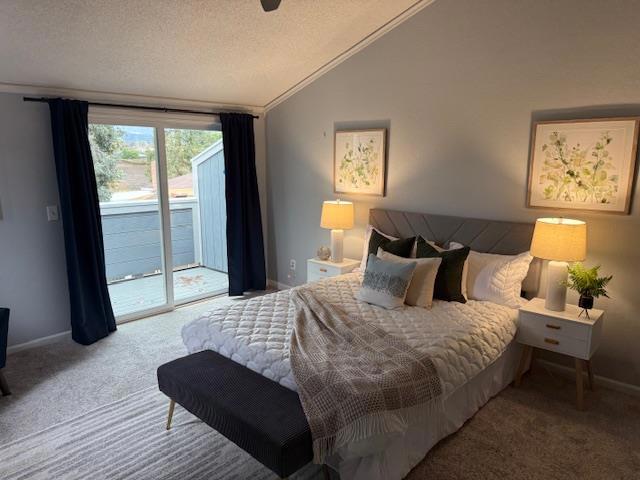 bedroom with lofted ceiling, carpet floors, a textured ceiling, and access to outside