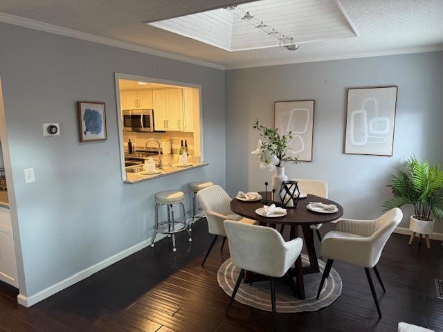 dining space featuring crown molding and dark hardwood / wood-style floors