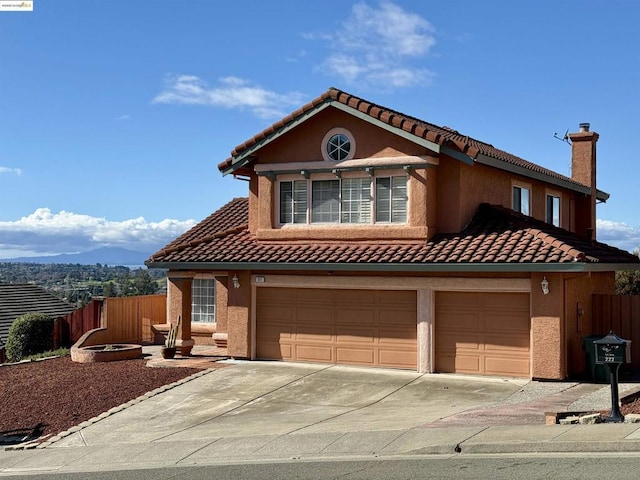 view of front of house with a garage and a mountain view