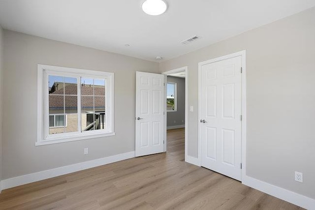 spare room featuring light wood-type flooring