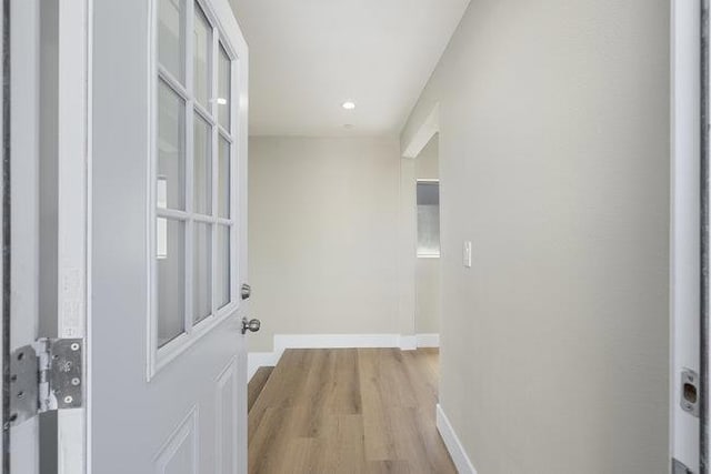 corridor with light hardwood / wood-style flooring