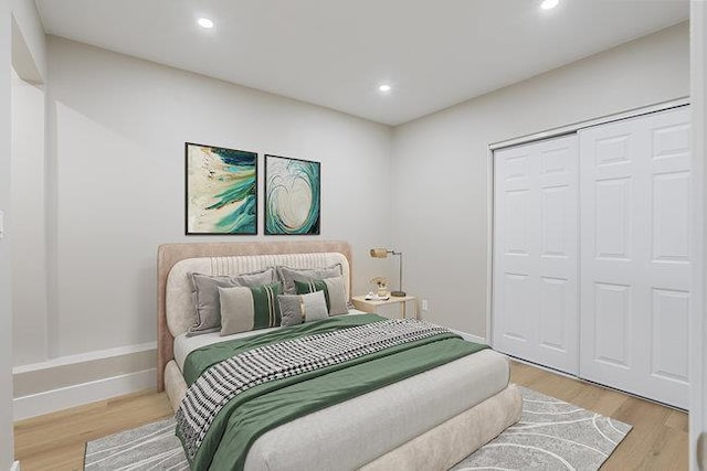 bedroom featuring hardwood / wood-style floors and a closet