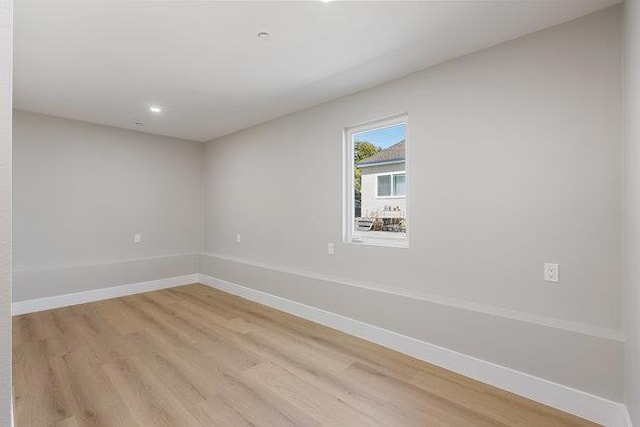 spare room with light hardwood / wood-style floors