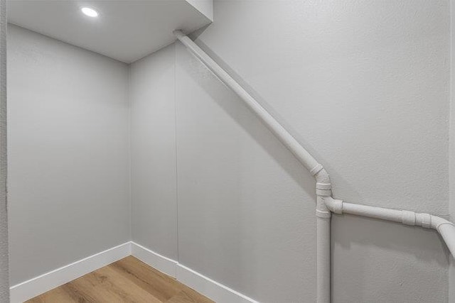 stairs with hardwood / wood-style floors