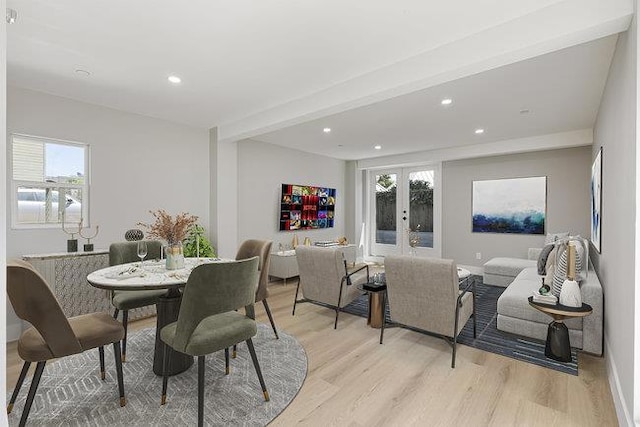 dining space with light hardwood / wood-style flooring, french doors, and beamed ceiling