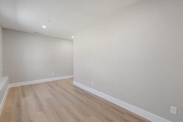 spare room featuring light hardwood / wood-style flooring