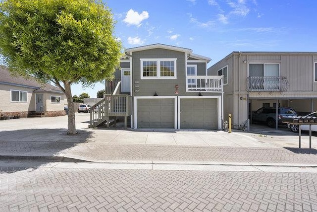 view of front of property featuring a balcony and a garage