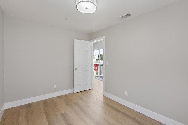 empty room with light hardwood / wood-style flooring