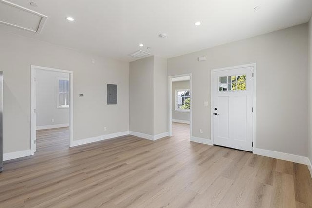 entryway with electric panel and light wood-type flooring