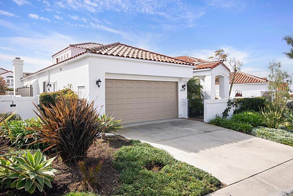 mediterranean / spanish-style home with a garage