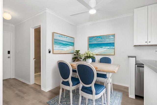 dining area with ornamental molding, ceiling fan, and light wood-type flooring