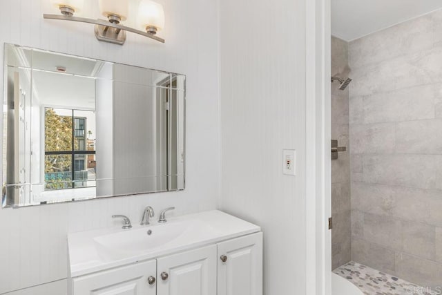 bathroom featuring vanity and tiled shower