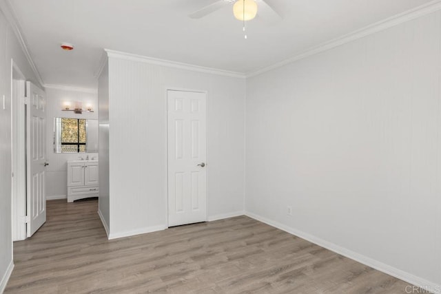 unfurnished bedroom featuring sink, ornamental molding, light hardwood / wood-style floors, and ceiling fan