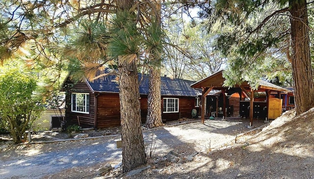 rear view of house featuring a carport