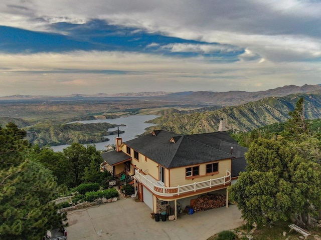 birds eye view of property featuring a water and mountain view