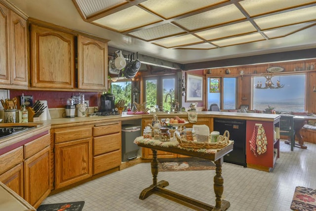 kitchen with pendant lighting, black dishwasher, sink, and french doors