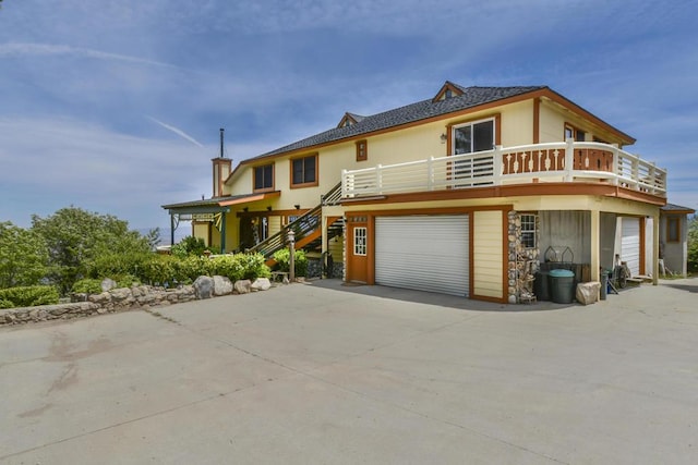 view of front of property featuring a garage and a deck