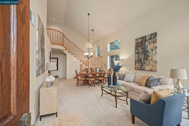 living room featuring light carpet, a towering ceiling, radiator heating unit, and a chandelier