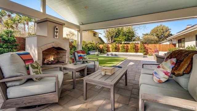 view of patio / terrace with an outdoor living space with a fireplace